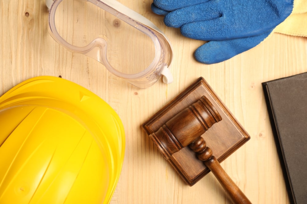 Construction equipment arranged on a wooden table, showcasing tools and machinery used in building projects.