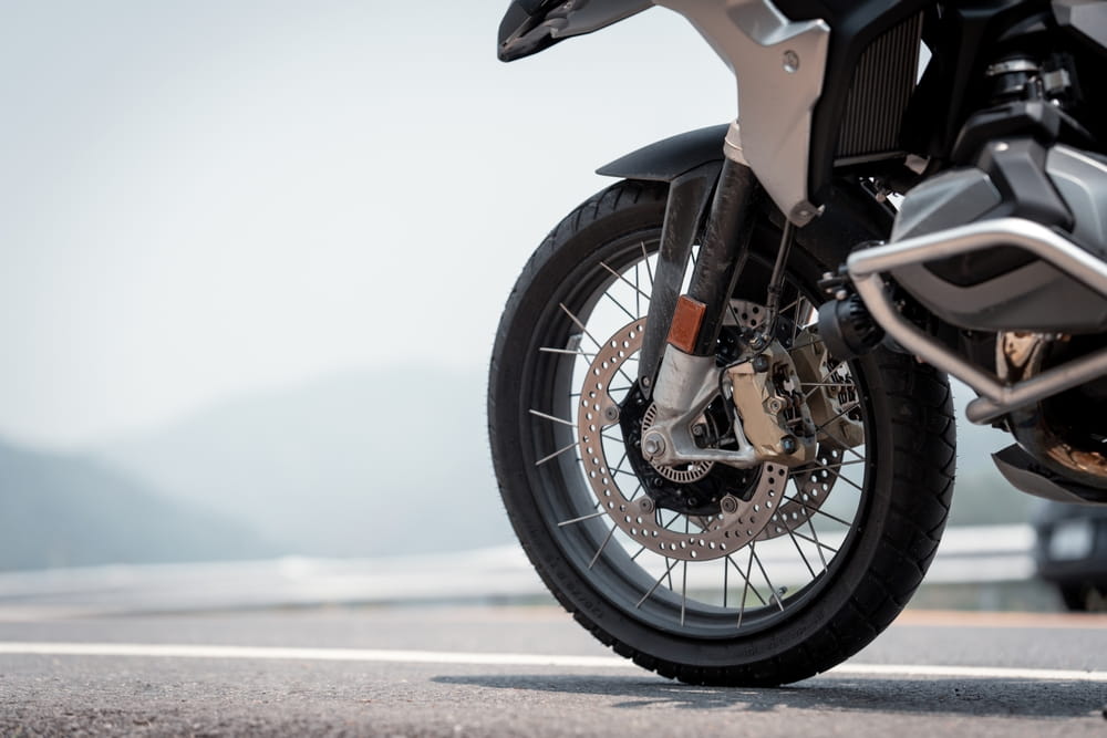 Close-up of a motorcycle front wheel highlighting mechanical components relevant to accident claims and insurance coverage in Florida