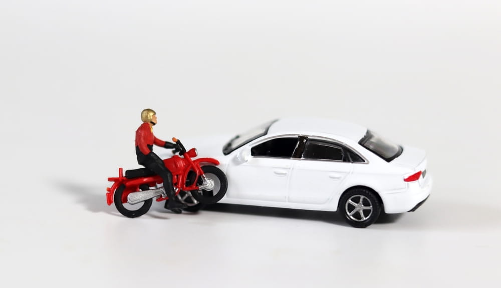 Toy model of a motorcycle colliding with a car representing simplified assumptions and bias in determining fault in injury claims